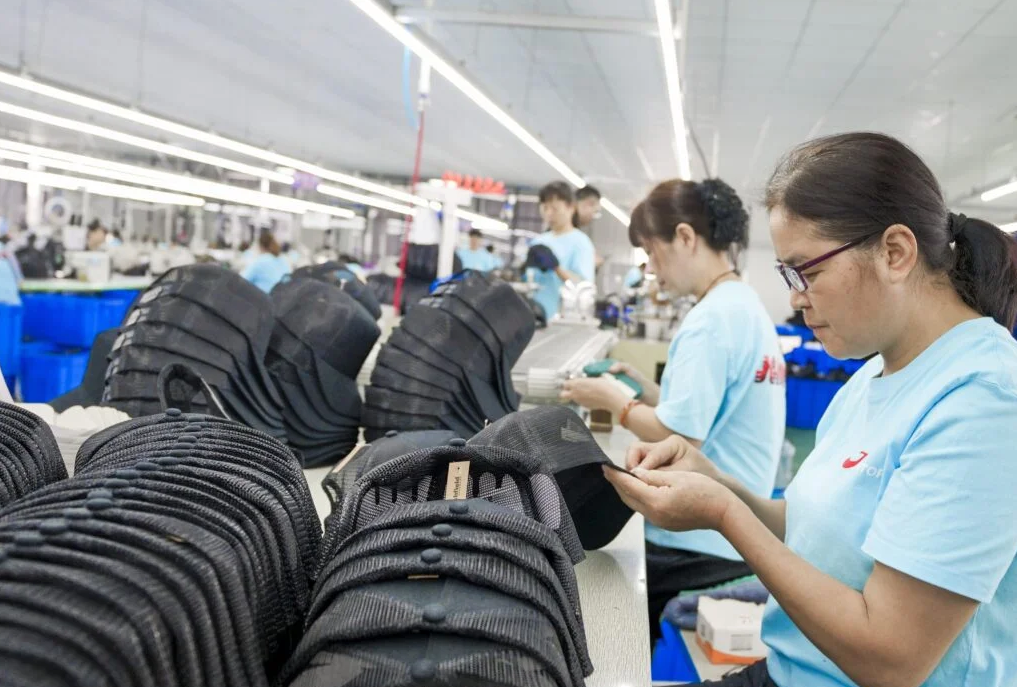 Quality inspector checking a performance cap before shipment
